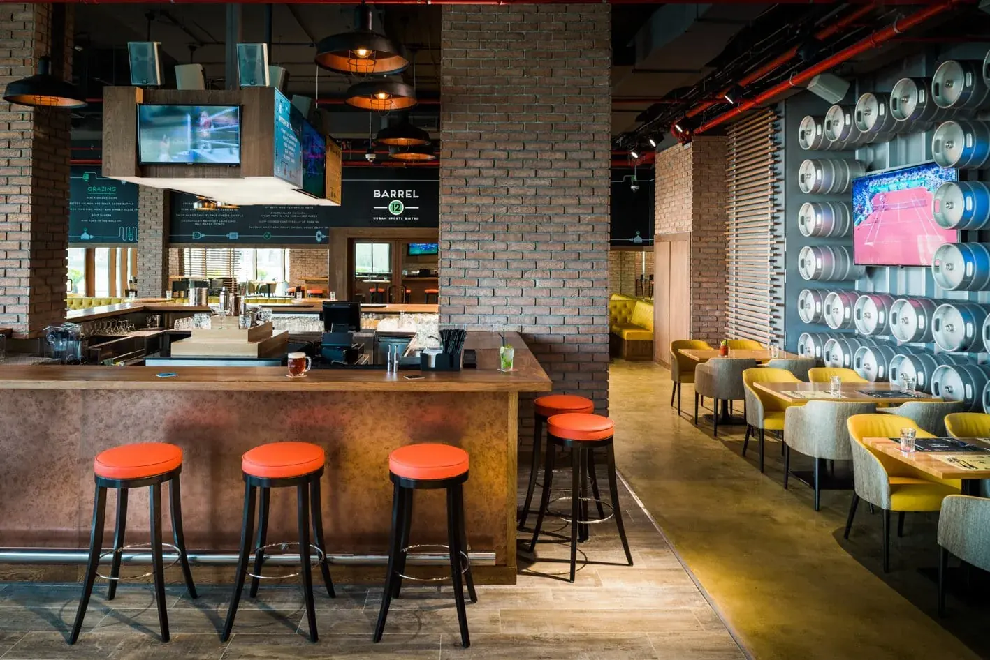 A restaurant interior with warm pendant lights and banquette seating.